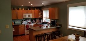 Manhattan house for rent - a kitchen with wooden cabinets and a counter top