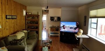 Manhattan house for rent - a living room with a couch and a tv