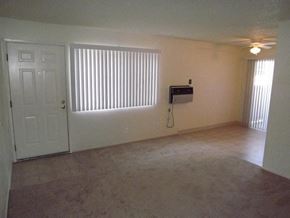 Modesto apartment for rent - an empty living room with a window and a door