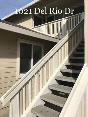 Hollister apartment for rent - A staircase with a railing and a window on a building.