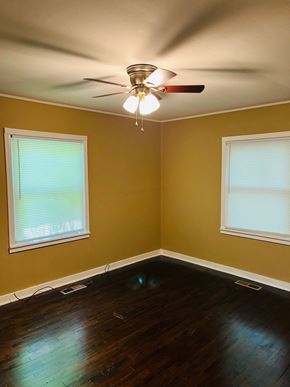 Jonesboro house for rent - A room with a ceiling fan and two windows.