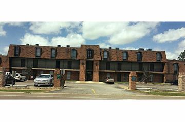Gretna apartment for rent - a large brick building with cars parked in front of it