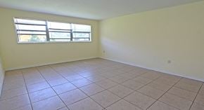 Tarpon Springs apartment for rent - A room with a window and tiled flooring.