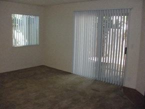 Gilroy apartment for rent - an empty living room with a sliding glass door