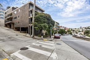 San Francisco apartment for rent - A street view with a building on the left and cars on the road.