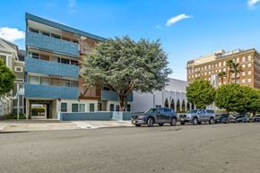 San Francisco apartment for rent - A blue and white building with a tree in front of it.