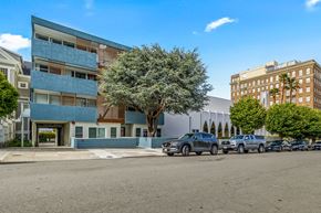 San Francisco apartment for rent - A blue and white building with a tree in front of it.