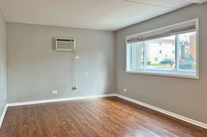 Oak Park apartment for rent - A room with a window and a wooden floor.