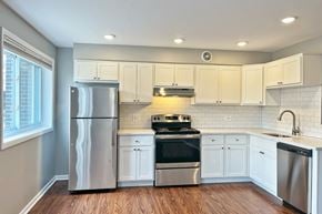 Oak Park apartment for rent - A modern kitchen with stainless steel appliances and white cabinets.
