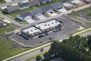 Fargo apartment for rent - A parking lot in front of a building with cars parked.