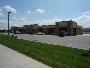 Fargo apartment for rent - A parking lot in front of a building with cars parked.