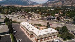 Provo apartment for rent - an aerial view of a building with a road and mountains in the background