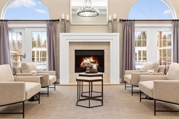 Novi apartment for rent - a living room with chairs and a fireplace