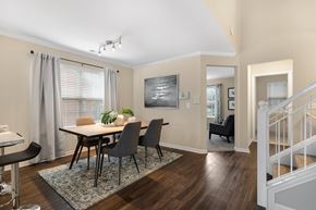 Novi apartment for rent - a dining room with a table and chairs and a staircase