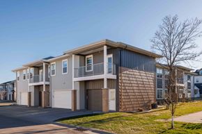 Fargo townhouse for rent - A modern apartment building with a mix of brick and siding exteriors.