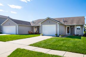 Belton triplex for rent - a white house with a driveway and a lawn
