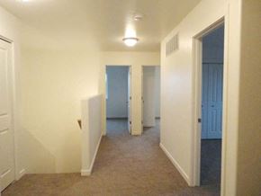 Sidney apartment for rent - an empty hallway with a blue door and white walls