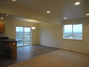 Sidney apartment for rent - A large empty room with a kitchen area and a view of the outside.