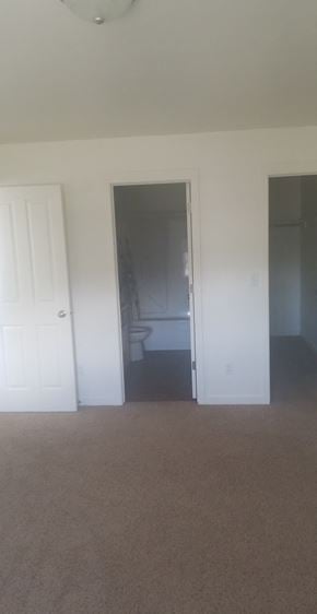 Sidney apartment for rent - A carpeted room with a doorway leading to another room.