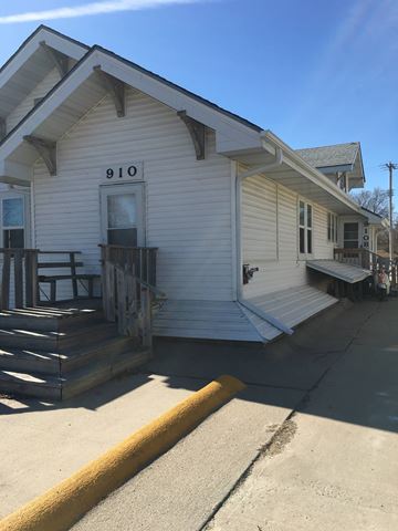 Kearney apartment for rent - the front of a white house with a porch and stairs