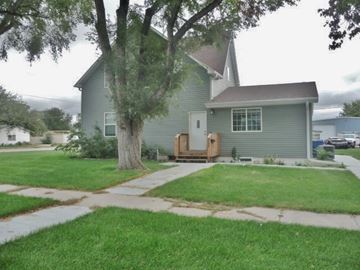 Kearney apartment for rent - a green house with a yard and a tree