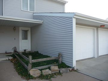 Kearney apartment for rent - a white house with a porch and a white garage door