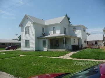 Kearney apartment for rent - a white house with a red car parked in front of it