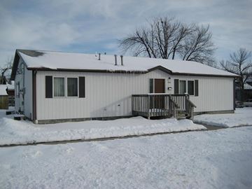 Kearney apartment for rent - a white house with a deck in the snow