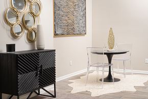 Jackson apartment for rent - a dining room with a round table and a black and white cabinet with a chair