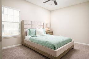 Jackson apartment for rent - a bedroom with a bed and a ceiling fan