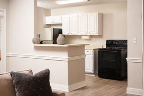 Jackson apartment for rent - A kitchen with white cabinets and a black oven.