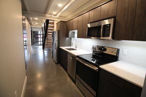 Lincoln apartment for rent - a kitchen with a stove and a microwave and a hallway with a staircase