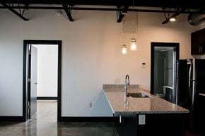 Richmond apartment for rent - a kitchen with a granite counter top and a black refrigerator