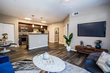 Las Vegas apartment for rent - A modern living room with a blue chair and a white coffee table.