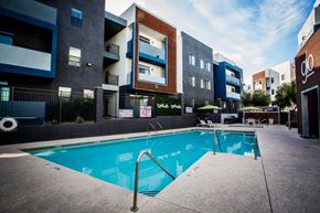 Las Vegas apartment for rent - A swimming pool is surrounded by apartment buildings.