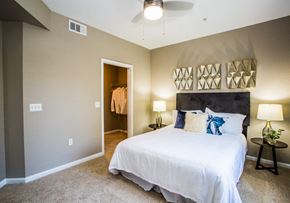 Las Vegas apartment for rent - A bedroom with a white bed and a ceiling fan.