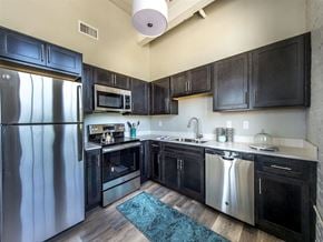 Providence apartment for rent - a kitchen with stainless steel appliances and black cabinets
