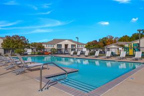 Sherwood apartment for rent - A large outdoor swimming pool surrounded by lounge chairs.