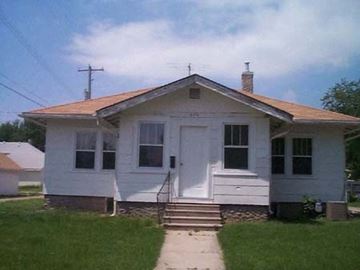 Kearney apartment for rent - a small white house with a sidewalk in front of it