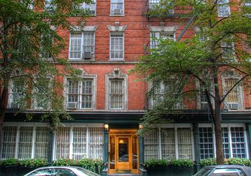 New York apartment for rent - a building with two cars parked in front of it
