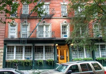 New York apartment for rent - a red brick building with cars parked in front of it