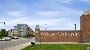 Chester apartment for rent - a brick wall with a university sign on the side of a street