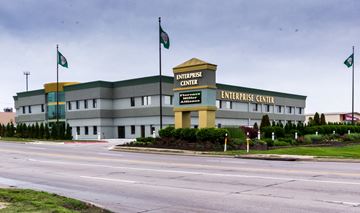 Omaha apartment for rent - A large grey building with a yellow roof and a sign that says Enterprise Center.