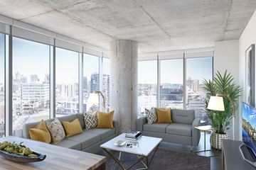 Nashville apartment for rent - a living room with couches and a coffee table and a city view