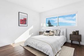 West Hollywood apartment for rent - A bedroom with a large bed and a framed picture on the wall.