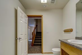 West Fargo townhouse for rent - the bathroom door is open to the hallway and the stairs to the bedroom and living