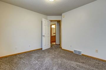 West Fargo townhouse for rent - a living room with carpet and a door to a bathroom