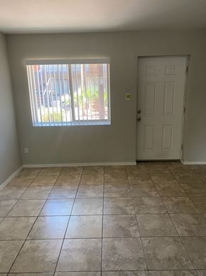 Phoenix apartment for rent - an empty living room with a window and a door
