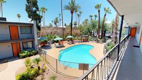 Phoenix apartment for rent - a swimming pool at a resort with palm trees