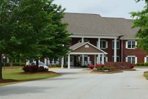 Palmetto apartment for rent - a large brick house with a car parked in front of it